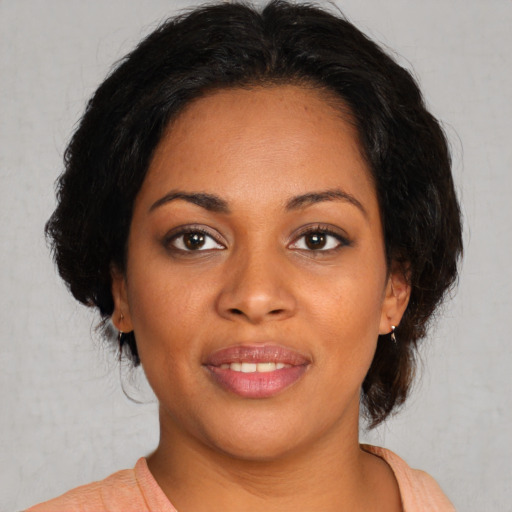 Joyful black young-adult female with medium  brown hair and brown eyes