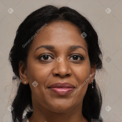 Joyful black adult female with medium  brown hair and brown eyes