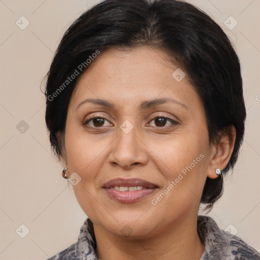 Joyful latino adult female with medium  brown hair and brown eyes