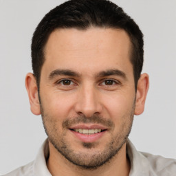 Joyful white young-adult male with short  brown hair and brown eyes