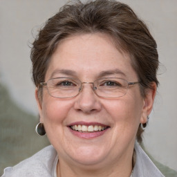 Joyful white adult female with medium  brown hair and blue eyes