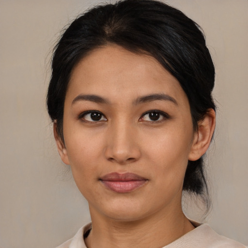 Joyful asian young-adult female with medium  brown hair and brown eyes