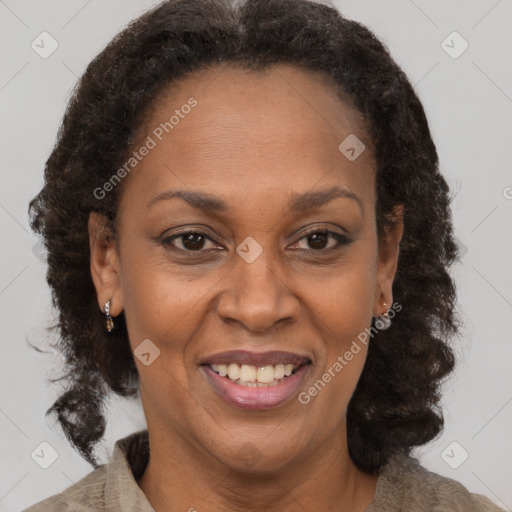 Joyful black adult female with medium  brown hair and brown eyes