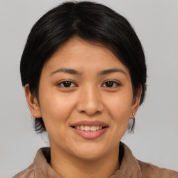 Joyful asian young-adult female with medium  black hair and brown eyes