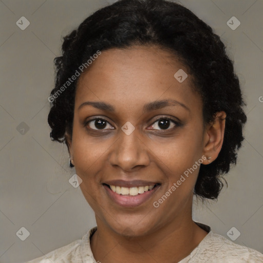 Joyful black young-adult female with short  black hair and brown eyes