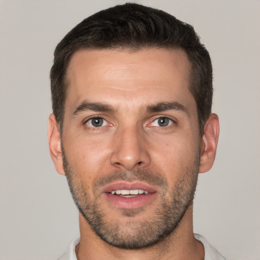 Joyful white young-adult male with short  brown hair and brown eyes