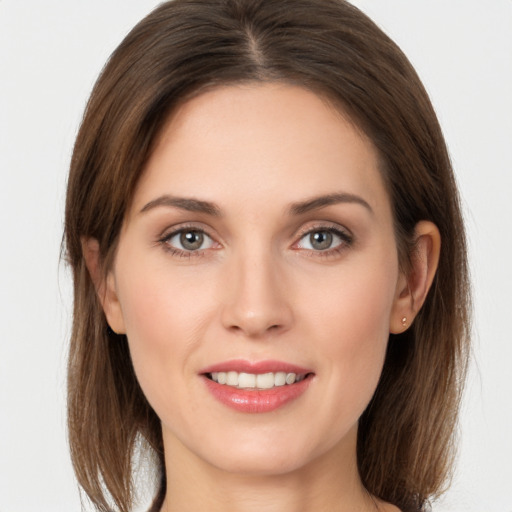 Joyful white young-adult female with long  brown hair and grey eyes