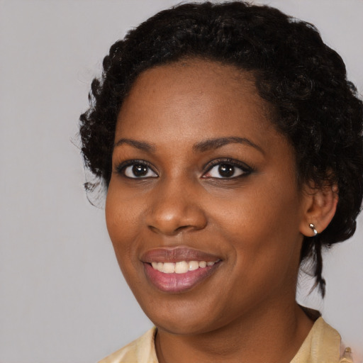 Joyful black young-adult female with medium  black hair and brown eyes