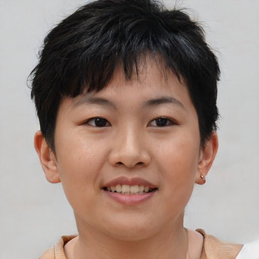 Joyful asian young-adult female with short  brown hair and brown eyes