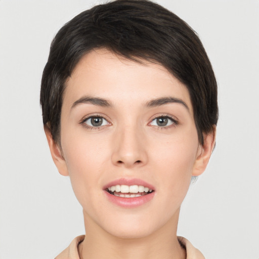 Joyful white young-adult female with short  brown hair and brown eyes