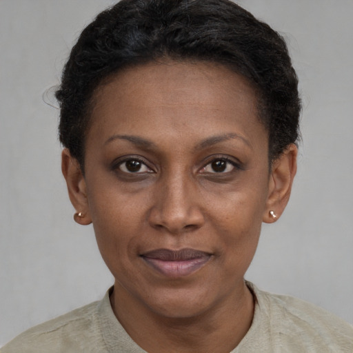 Joyful latino adult female with short  brown hair and brown eyes