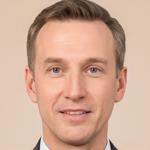 Joyful white adult male with short  brown hair and grey eyes