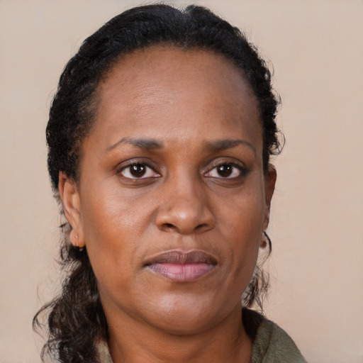 Joyful black adult female with medium  brown hair and brown eyes