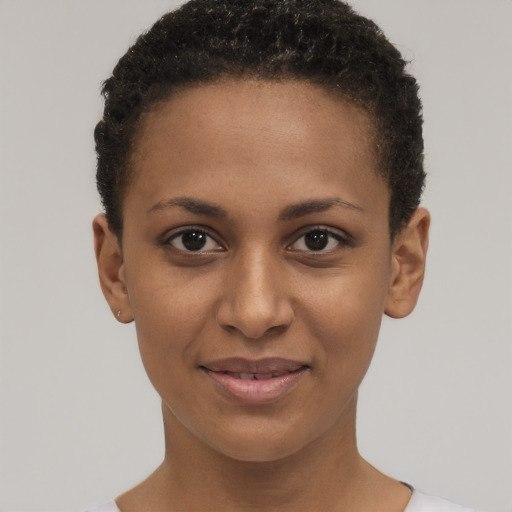 Joyful black young-adult female with short  brown hair and brown eyes