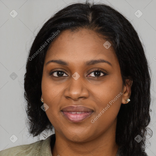 Joyful black young-adult female with long  black hair and brown eyes