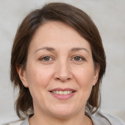 Joyful white adult female with medium  brown hair and brown eyes