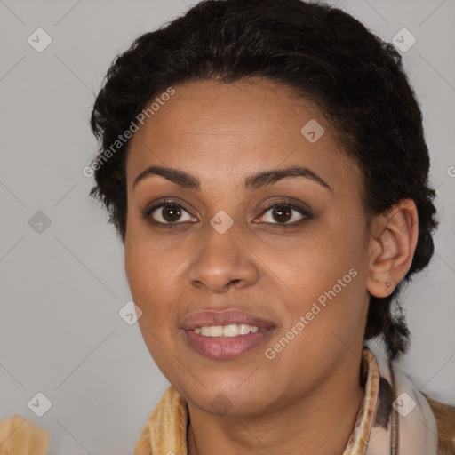 Joyful black young-adult female with long  brown hair and brown eyes