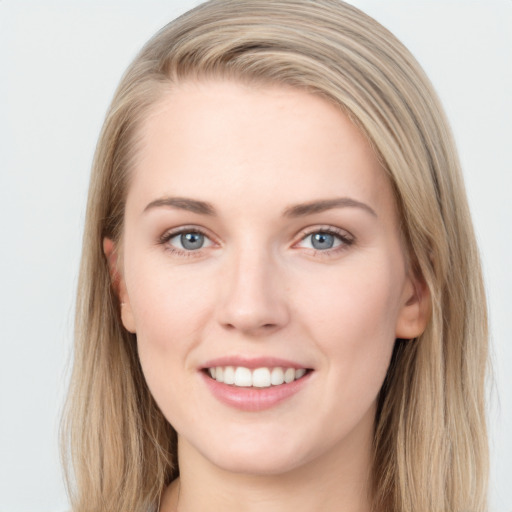 Joyful white young-adult female with long  brown hair and grey eyes