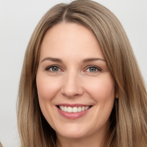 Joyful white young-adult female with long  brown hair and brown eyes