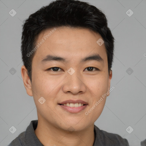 Joyful asian young-adult male with short  black hair and brown eyes