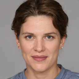 Joyful white adult female with medium  brown hair and grey eyes