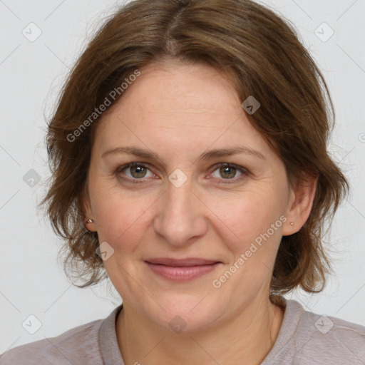 Joyful white adult female with medium  brown hair and grey eyes