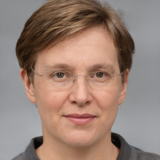 Joyful white adult female with medium  brown hair and blue eyes