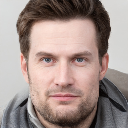 Joyful white adult male with short  brown hair and grey eyes