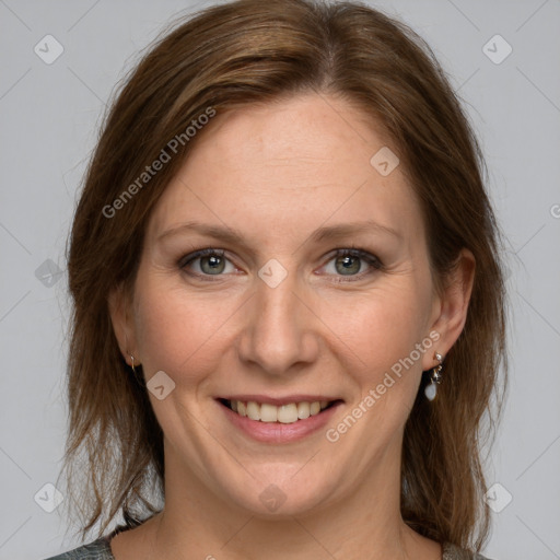 Joyful white adult female with medium  brown hair and grey eyes