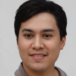 Joyful asian young-adult male with short  black hair and brown eyes