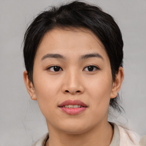 Joyful asian young-adult female with medium  brown hair and brown eyes