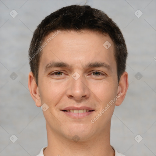 Joyful white young-adult male with short  brown hair and brown eyes