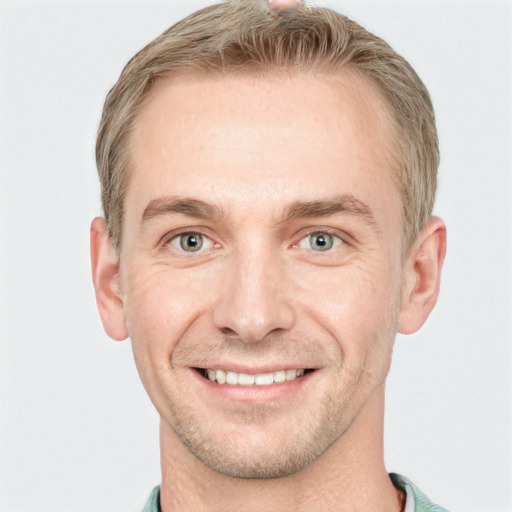 Joyful white adult male with short  brown hair and grey eyes