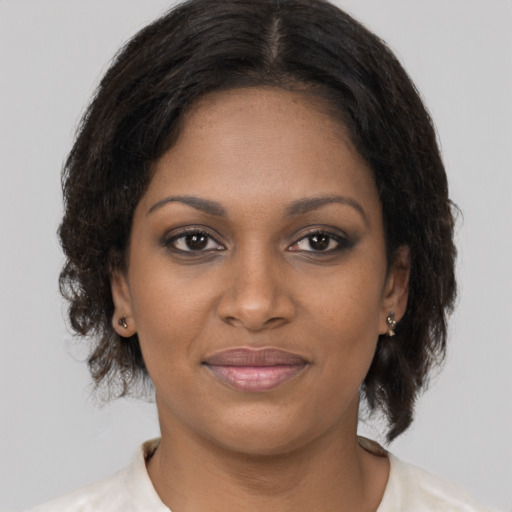 Joyful black young-adult female with medium  brown hair and brown eyes