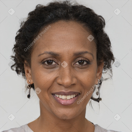 Joyful black adult female with short  brown hair and brown eyes