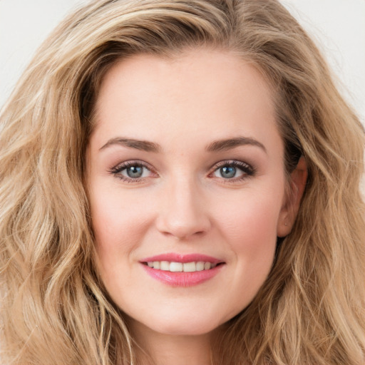 Joyful white young-adult female with long  brown hair and green eyes