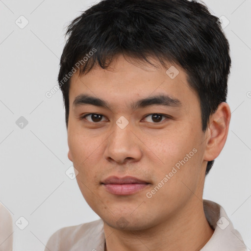 Joyful white young-adult male with short  black hair and brown eyes