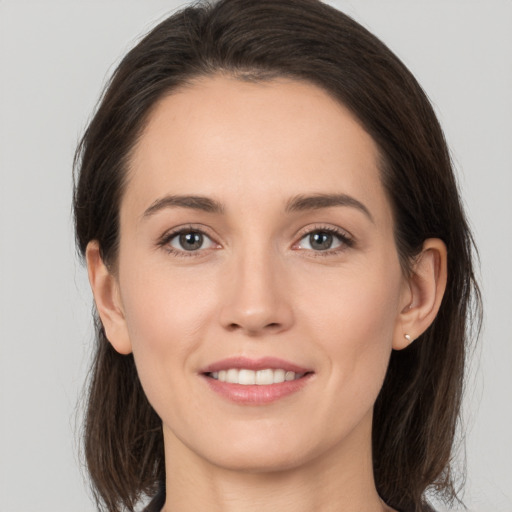 Joyful white young-adult female with medium  brown hair and brown eyes