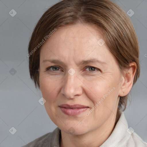 Joyful white adult female with medium  brown hair and grey eyes