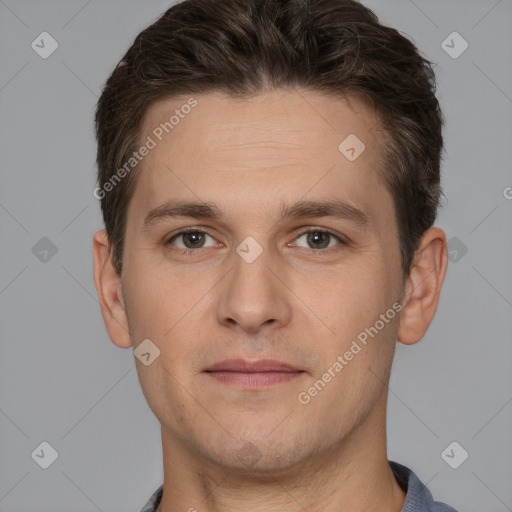 Joyful white young-adult male with short  brown hair and grey eyes