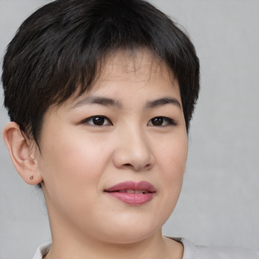 Joyful asian young-adult female with short  brown hair and brown eyes