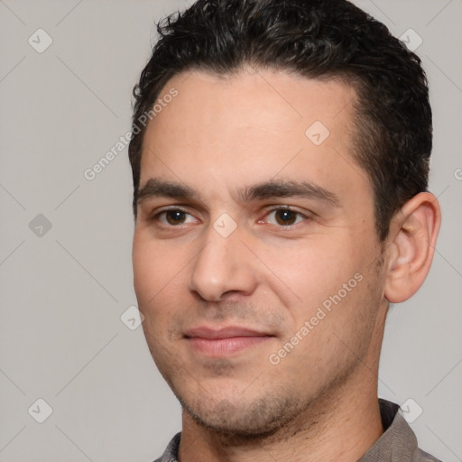 Joyful white young-adult male with short  black hair and brown eyes