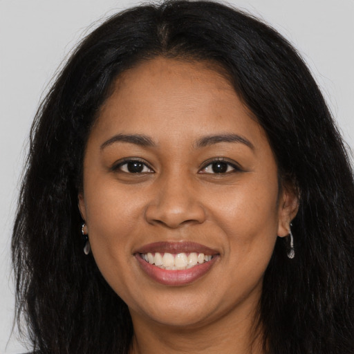 Joyful latino young-adult female with long  brown hair and brown eyes