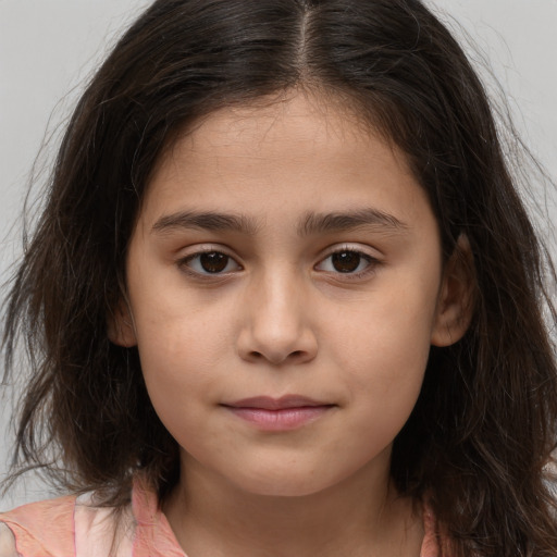 Joyful white child female with long  brown hair and brown eyes