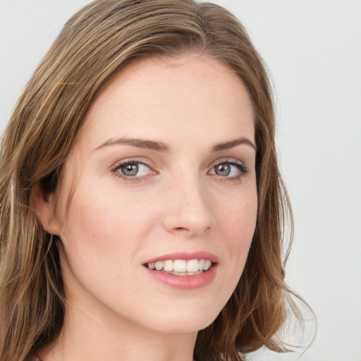 Joyful white young-adult female with long  brown hair and blue eyes