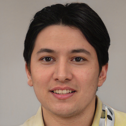 Joyful white young-adult male with short  black hair and brown eyes
