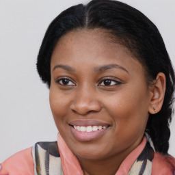 Joyful black young-adult female with medium  brown hair and brown eyes