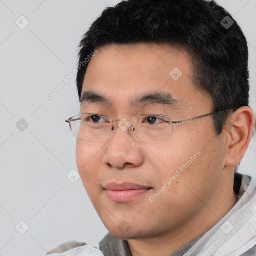 Joyful asian young-adult male with short  black hair and brown eyes