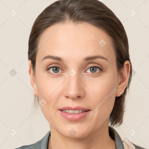 Joyful white young-adult female with medium  brown hair and grey eyes