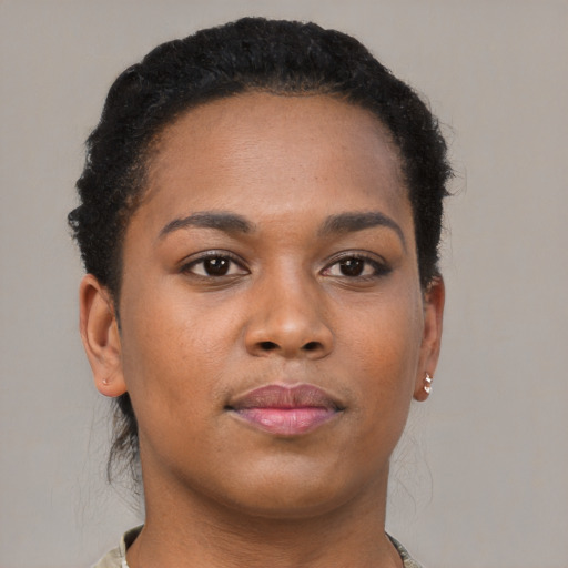 Joyful black young-adult female with short  brown hair and brown eyes